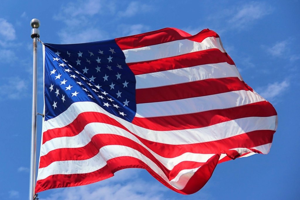 U.S. flag flying against blue sky