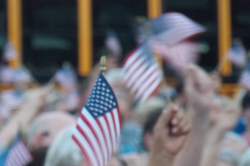 Supporters waving small American flags at a rally
